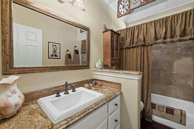 bathroom with toilet, shower / tub combo with curtain, and vanity