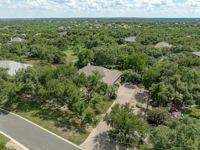 birds eye view of property with a view of trees