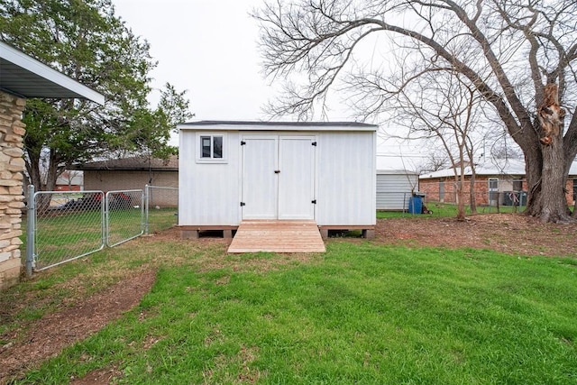 view of shed with a gate and fence