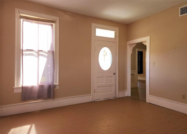 entryway with light wood-type flooring and visible vents