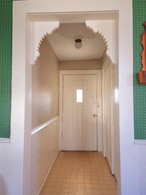 entryway with a wainscoted wall and light floors