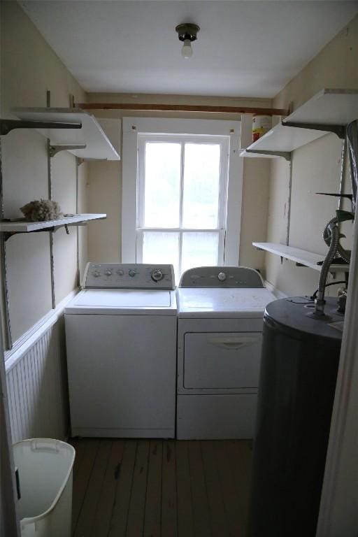 laundry room with laundry area, dark wood-type flooring, and washing machine and clothes dryer