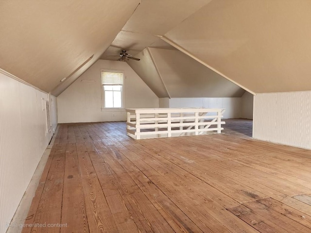 bonus room with lofted ceiling and wood finished floors