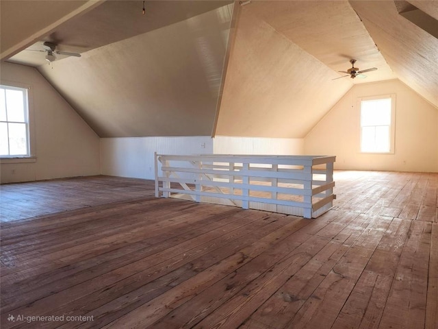 additional living space featuring lofted ceiling and wood finished floors