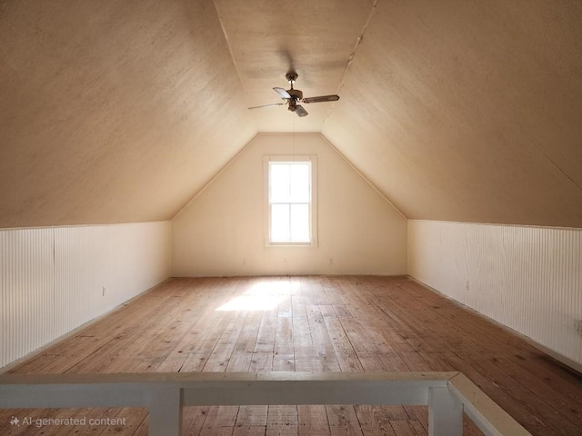 bonus room featuring lofted ceiling, light wood-style floors, and a ceiling fan