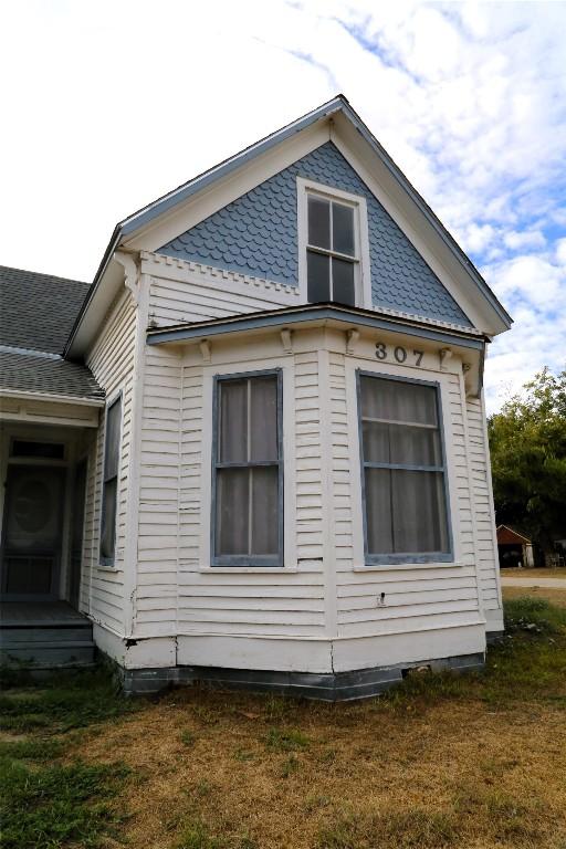 view of side of home featuring a lawn