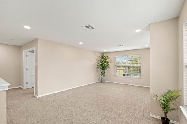 unfurnished room with light carpet, visible vents, and recessed lighting