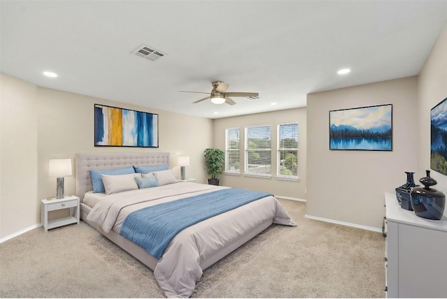 bedroom with light carpet, recessed lighting, visible vents, and baseboards