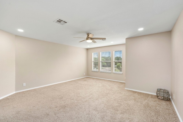 empty room featuring baseboards, recessed lighting, visible vents, and light colored carpet