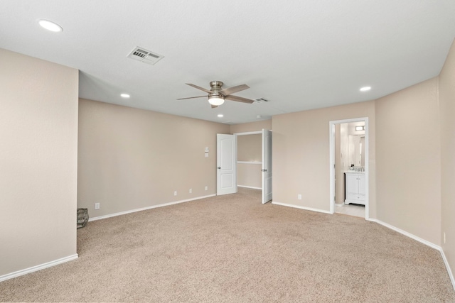 spare room with light carpet, recessed lighting, and baseboards