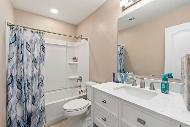 bathroom with visible vents, a textured wall, toilet, shower / bath combo with shower curtain, and vanity