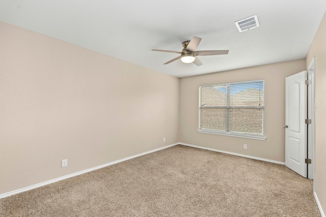 empty room with light carpet, baseboards, visible vents, and a ceiling fan