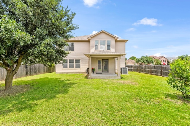 rear view of property with a yard, a fenced backyard, a patio, and central air condition unit