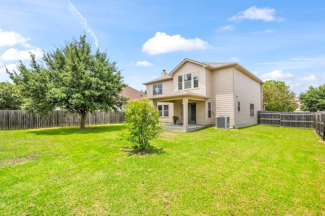 rear view of property featuring a patio area, a fenced backyard, a lawn, and central air condition unit