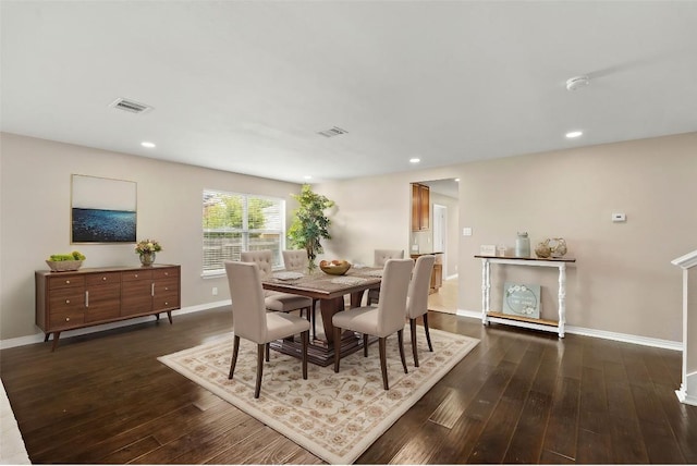 dining space with dark wood-style floors, recessed lighting, visible vents, and baseboards