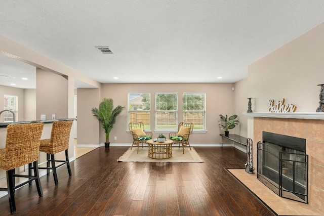 dining space featuring a fireplace, recessed lighting, visible vents, wood finished floors, and baseboards