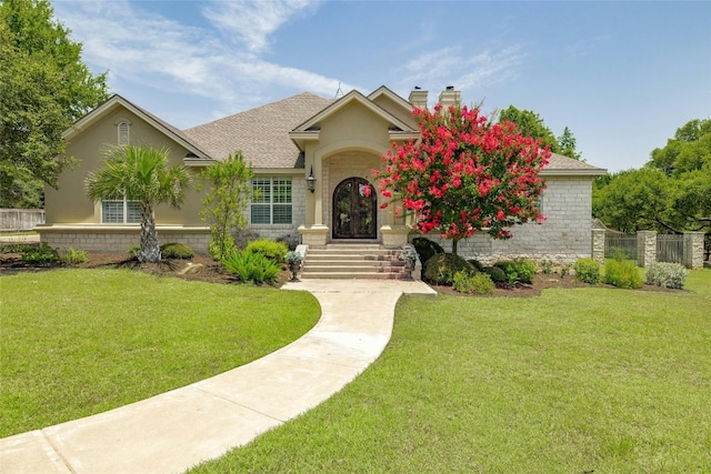 view of front of property with a chimney, fence, a front lawn, and roof with shingles