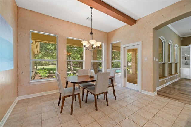 dining area with light tile patterned floors, a notable chandelier, baseboards, and beam ceiling