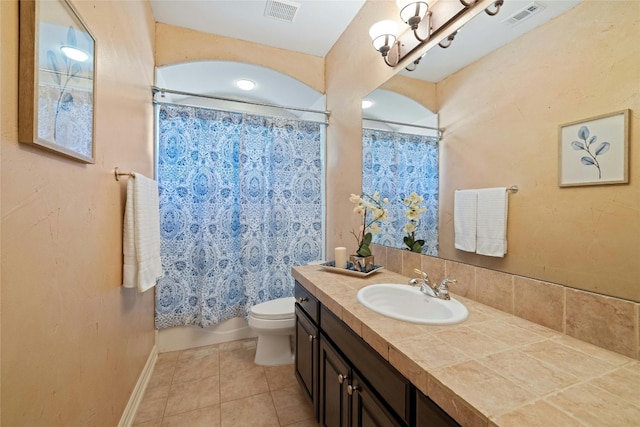 bathroom with toilet, vanity, tile patterned flooring, and visible vents