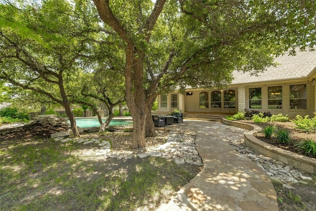 view of yard featuring a patio area and an outdoor pool