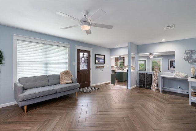 living room featuring visible vents, baseboards, a ceiling fan, and recessed lighting