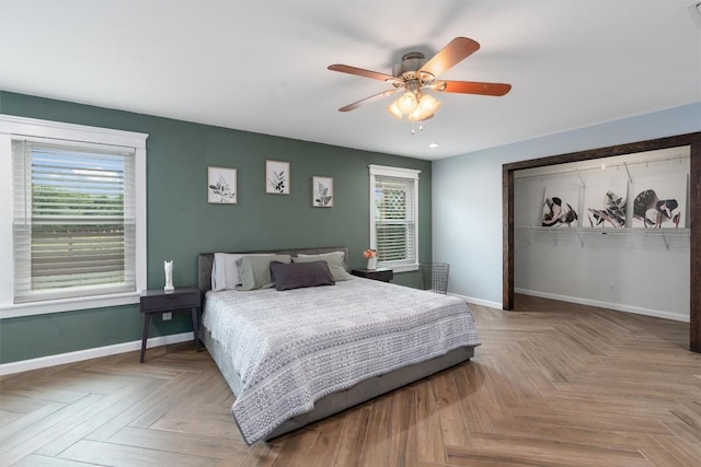 bedroom with a ceiling fan, visible vents, baseboards, and a closet