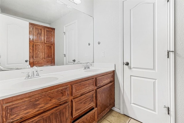 bathroom featuring double vanity, a sink, and tile patterned floors