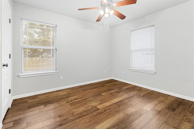 unfurnished room with a ceiling fan, baseboards, and wood finished floors