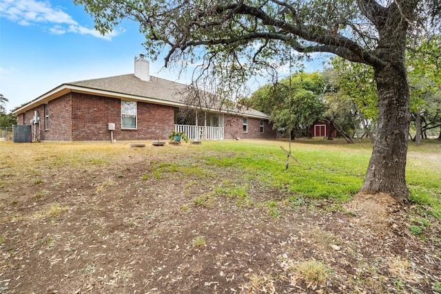 3640 Big Divide Rd, Copperas Cove, TX 76522 - rear view of property featuring brick siding, a chimney, a yard, and roof with shingles