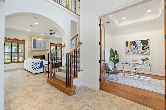 41 Tiburon Dr, The Hills, TX 78738 - foyer with a ceiling fan, recessed lighting, arched walkways, stairs, and a large fireplace