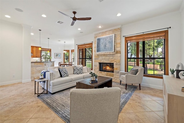 41 Tiburon Dr, The Hills, TX 78738 - living room with ornamental molding, recessed lighting, ceiling fan, a stone fireplace, and light tile patterned floors