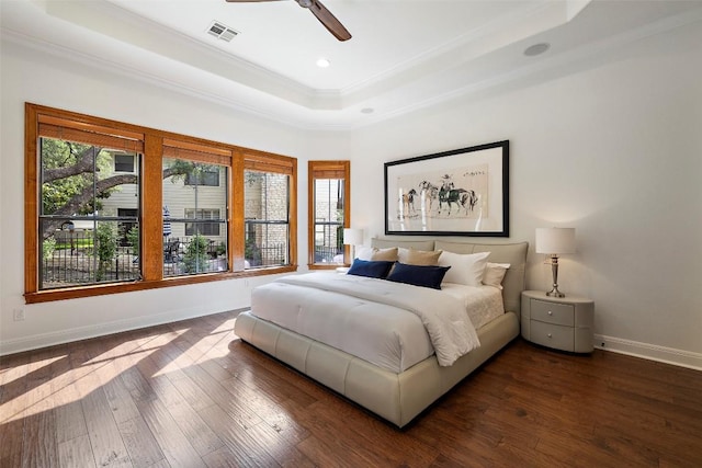 41 Tiburon Dr, The Hills, TX 78738 - bedroom with a raised ceiling, ornamental molding, dark wood-style floors, recessed lighting, and a ceiling fan