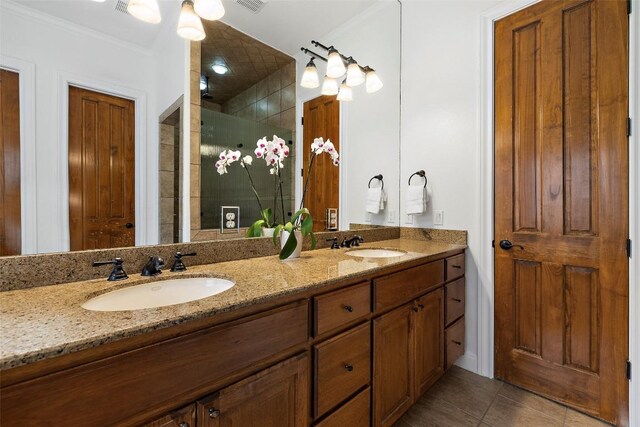 41 Tiburon Dr, The Hills, TX 78738 - full bathroom featuring double vanity, tile patterned floors, a stall shower, and crown molding