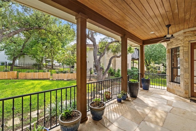 view of patio with ceiling fan and fence