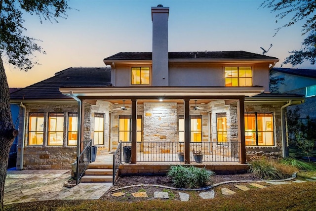 41 Tiburon Dr, The Hills, TX 78738 - rear view of property featuring stone siding, a porch, and ceiling fan