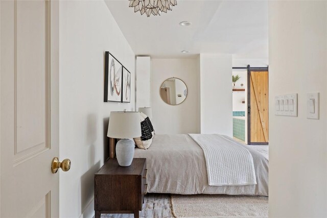 5242 Mccormick Mountain Dr Unit E, Austin, TX 78734 - bedroom with a barn door and baseboards
