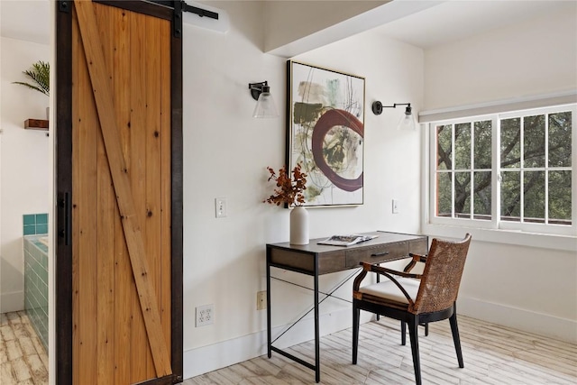 5242 Mccormick Mountain Dr Unit E, Austin, TX 78734 - home office with a barn door and wood finished floors