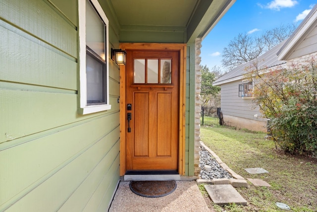 entrance to property featuring fence