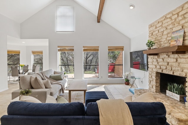 living area featuring light tile patterned floors, high vaulted ceiling, and a stone fireplace