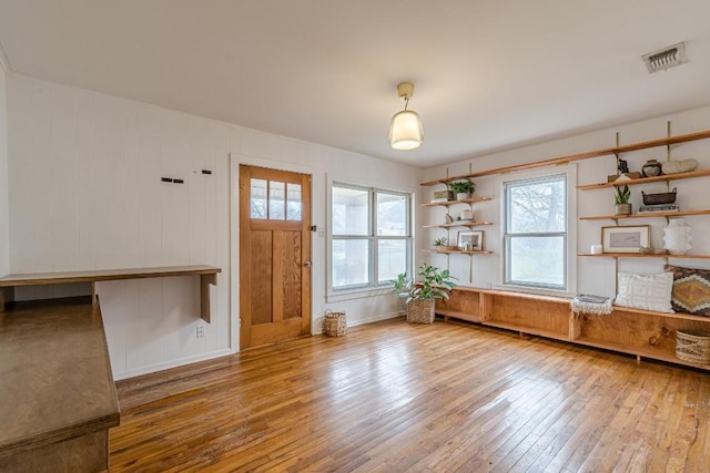 interior space with plenty of natural light, light wood-type flooring, and visible vents