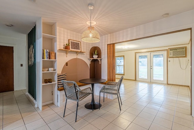 dining area with a wall unit AC, light tile patterned floors, baseboards, and french doors