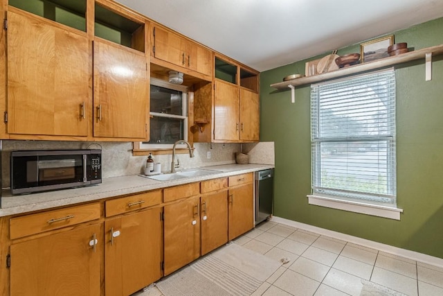 kitchen with open shelves, light countertops, decorative backsplash, a sink, and dishwasher