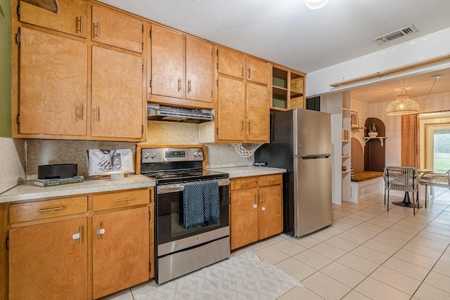 kitchen with appliances with stainless steel finishes, visible vents, light countertops, and under cabinet range hood