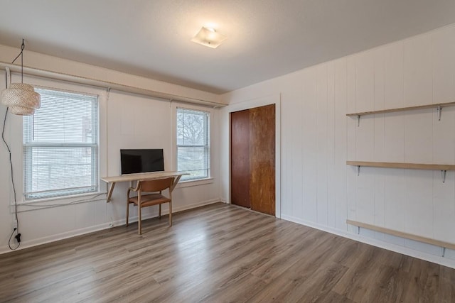 office featuring baseboards and wood finished floors