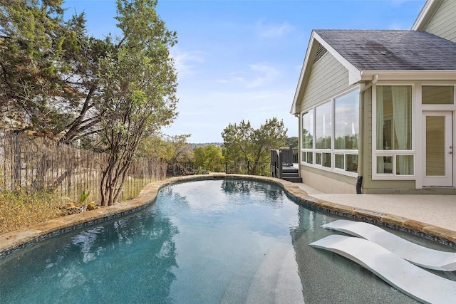 view of pool with a sunroom, fence, and a fenced in pool