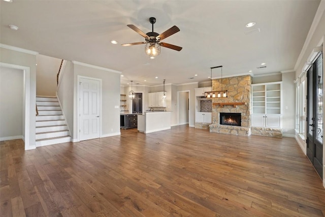 unfurnished living room featuring ornamental molding and dark wood-style floors