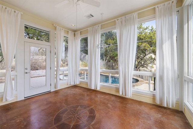 unfurnished sunroom with ceiling fan and visible vents