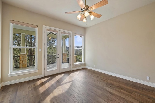 interior space featuring a ceiling fan, baseboards, dark wood-style flooring, and french doors