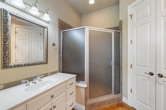 full bathroom featuring a stall shower, tile patterned flooring, and vanity