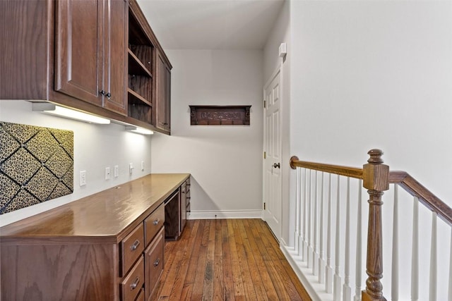 bar with dark wood-style floors and baseboards